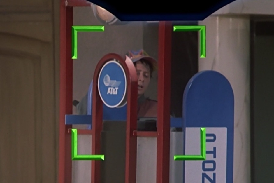 <p><strong>Figure 1.1</strong> As Doc Brown scopes out the situation in the futuristic town square, he spots Marty’s son approaching a pay phone, where we can see the AT&T logo on signage.</p>