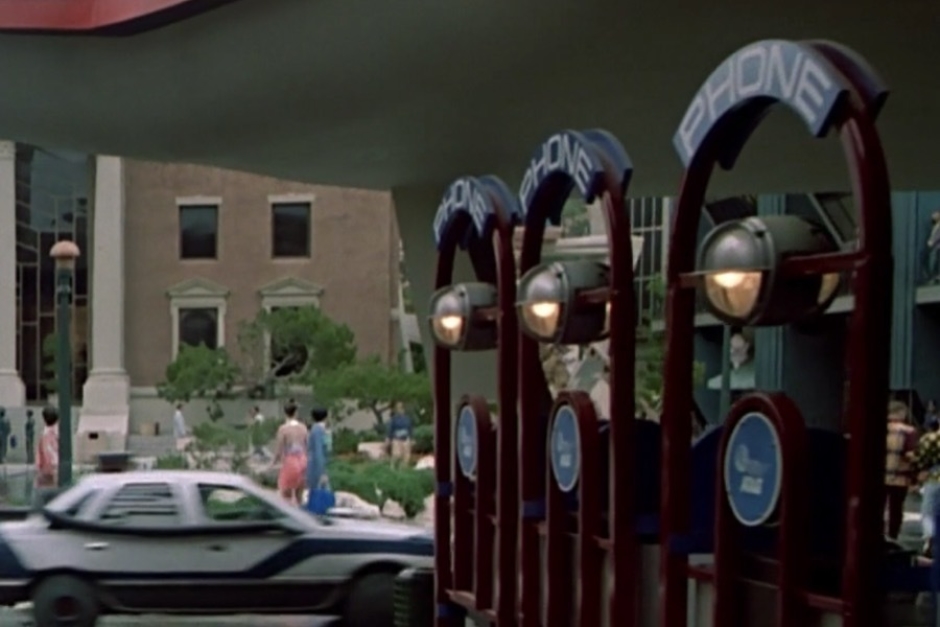 <p><strong>Figure 1.2</strong> Then, as Marty enters the town square on his mission, to his right we see more pay phones bearing the AT&T logo.</p>