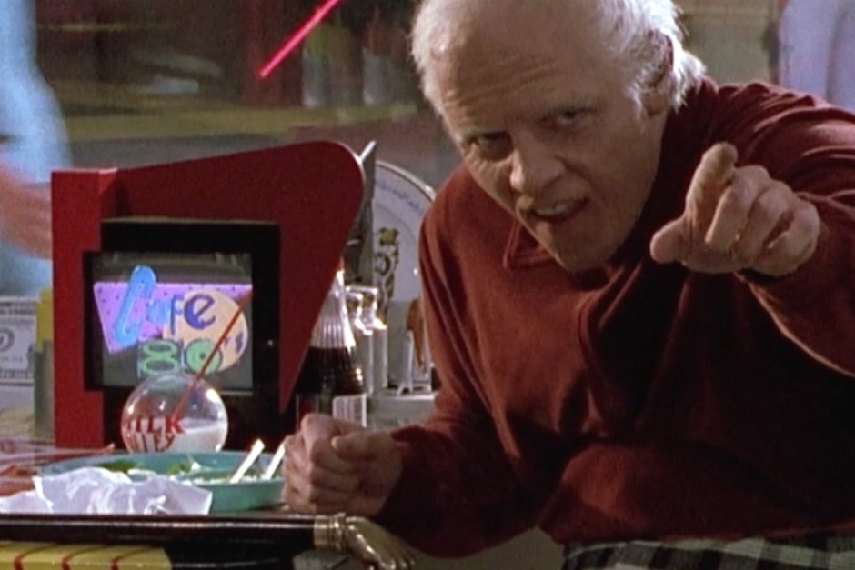 <p><strong>Figure 1.3</strong> When old 2015 Biff calls Marty out, we see the Cafe 80s logo displayed on a small retro-styled tabletop TV. Interesting that a TV replaces what would have been a little jukebox in a 50s diner.</p>
