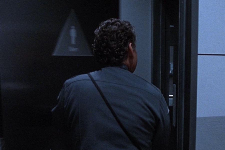 <p><strong>Figure 5.5</strong> In several shots, we can see the building’s restroom door signage, which is triangular to match the Cyberdyne mark.</p>