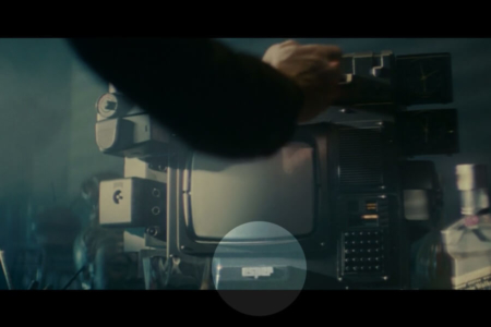 <p><strong>Figure 1.3</strong> As Deckard inserts the photo into his home Esper terminal, the Esper logotype is seen below the monitor (highlighted).</p>
