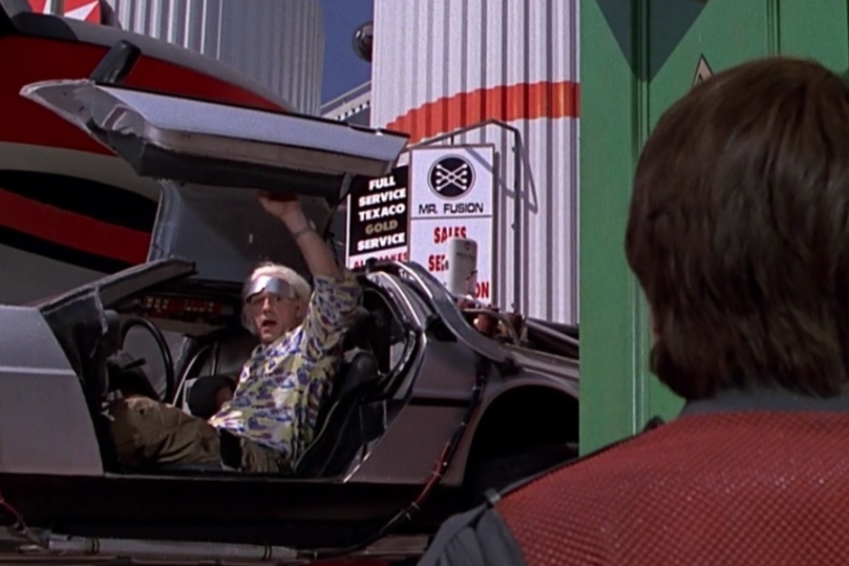 <p><strong>Figure 2.4</strong> When Doc swoops in to pick Marty up from the town square, we see the Mr. Fusion logo in the background, on the service station signage.</p>