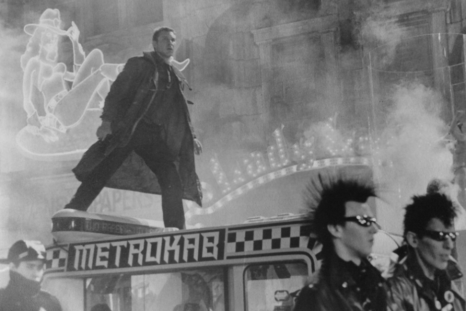 <p><strong>Figure 2.4</strong> Black and white press kit photo of Deckard standing on a Metrokab, with the logo clearly visible. Photo courtesy of Tom Southwell.
</p>
