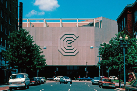 <p><strong>Figure 1.6</strong> The logo for the Washington Convention Center created in stone and mounted to its exterior facade. The octagonal building was imploded in 2004. Source: <em>Lance Wyman: The Monograph</em></p>