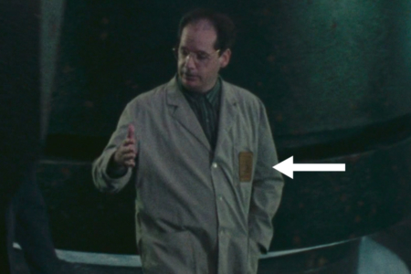 <p><strong>Figure 4.1</strong> A scientist advises Coheegan on the possibility of activating the alien technology discovered in the Pyramid Mines—the logo on a yellow patch is glimpsed on his gray lab coat.</p>