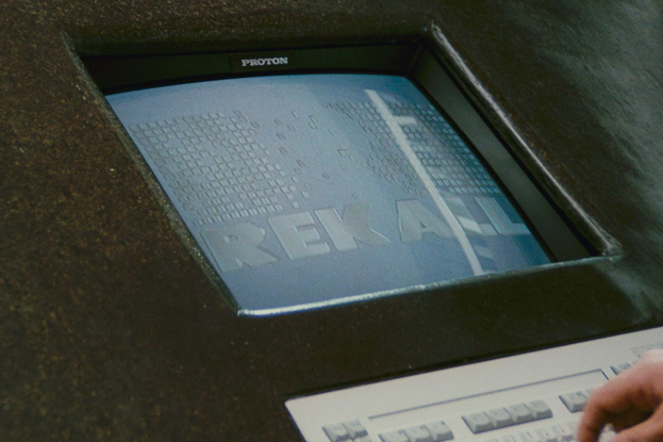 <p><strong>Figure 2.2</strong> The Rekall logo on an info console in the lobby.</p>