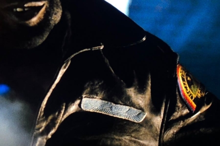 <p><strong>Figure 6.1</strong> The large Weylan-Yutani wings embroidered patch worn by ship’s officers, seen here on Parker’s jacket.</p>